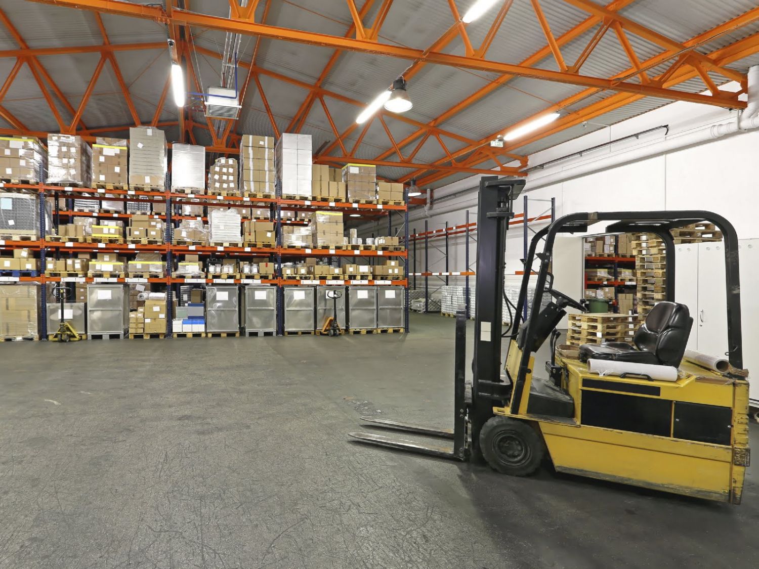 Forklift in front of shelving system at warehouse